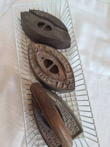 lot 1074 image: Three sad irons, missing handles on two