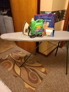 lot 1102 image: Ironing board, iron, dryer sheets, Gain half full, Braums thermal bag