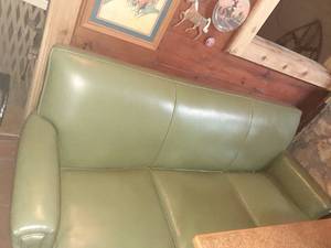 lot 1323 image: Vintage green vinyl couch. Approximately 73 inches long. Appears to have no tears on the outside, there are 2 small holes on the bottom. See pictures