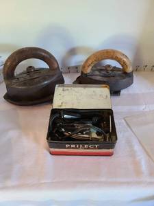 lot 1347 image: Dubuque Potts flat iron with resting plate, St. Louis flat iron, Protectors travel iron in original tin box
