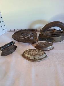 lot 1349 image: Large and small irons, resting plate. Large iron has damage to wooden handle