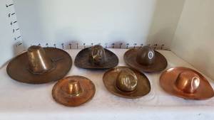 lot 1369 image: Metal cowboy hats and sombreros (one solid copper)