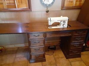 lot 1407 image: Sewing cabinet with a Viking Husqvarna sewing machine. Seven drawers, one has contents inside. Comes with carrying case and manuals. Closed it measures 30 x 46 x 19