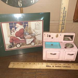 lot 1419 image: Vintage pink stovesink. The stovesink is pictured in Santas wagon. Art work is done by Sandi Gore Evans signed & numbered 6951000.  Stovesink purchased from Sandi Gore Evans Studio (Augusta Ks.)