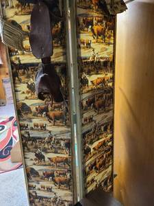 lot 2010 image: Wood framed 2 panel screen, wire and cowboy scene fabric, 70 tall, each panel is 14.5. Hanging items not included.