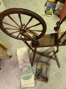 lot 2025 image: Spinning wheel, book, flour bag