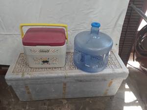 lot 3005 image: Styrofoam cooler (13 x 35 x 13) and a Coleman Lil and a Primo water jug
