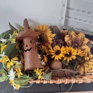 lot 3020 image: Fall decor. 18 inch basket with metal witchjack-o-lantern and faux flowers.