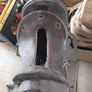 lot 3076 image: (2) Vintage saddles. One is 14 inch saddle, the other is McLellan saddle. US Army 11 inch seat