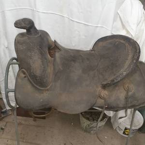 lot 3081 image: Vintage saddle, approximately 17 inch seat. Comes with metal saddle stand. 33.5 x 27 x 20