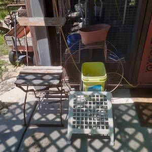 lot 4007 image: Miscellaneous backyard items. Plant stand, metalwood chair (needs repair), metal foot stand and a 12 bucket of rocks