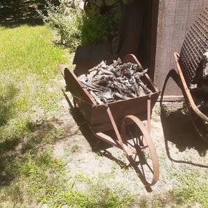 lot 4017 image: Wrought iron wheelbarrow with sticks
