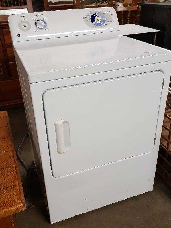 lot 1005 image: GE electric extra large dryer with a few knobs missing.  Was being used this way