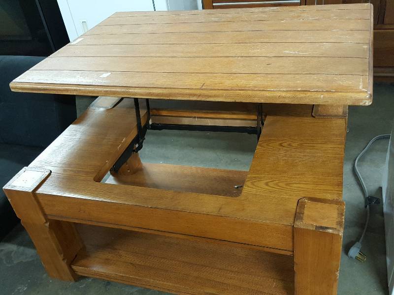 lot 1007 image: Wild deal here with this Oak wood coffees table the has a riser to bring the table to you and with a shelf underneath