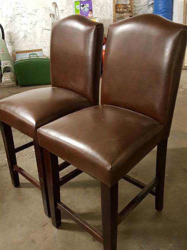 lot 1035 image: Pair of 39 tall Brown leather chairs in nice condition with no blemishes