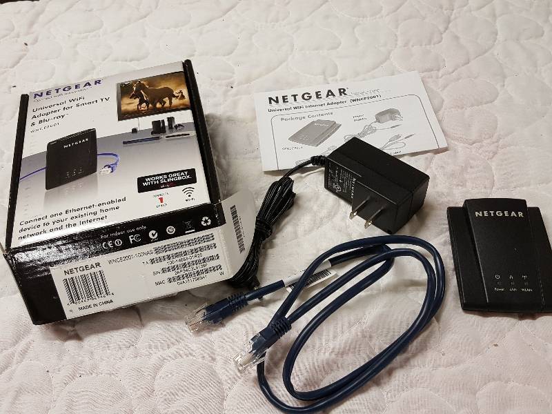 lot 1086 image: New in the box Universal WiFi Home Theater Adapter by Netgear WNCE2001