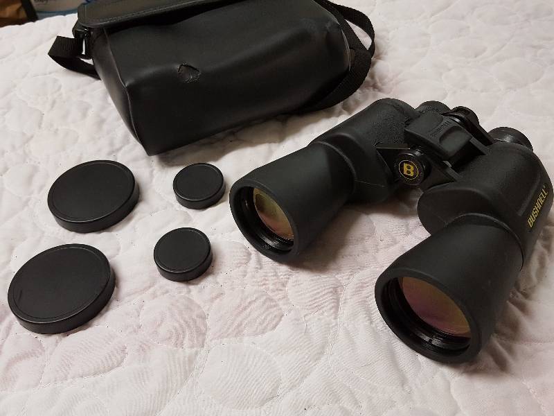 Another set of Bushnell 131056 10X50 wide angle binoculars with the case and lens covers In