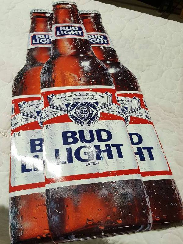 lot 1102 image: Didnt measure it when I did the photos so Im going to guess at 25-30 tall metal white back Bud Light Beer wall sign