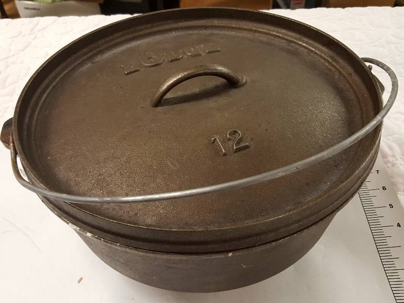 lot 1145 image: Bring help to load this Lodge Dutch Oven and again its seasoned and ready to cook the beans