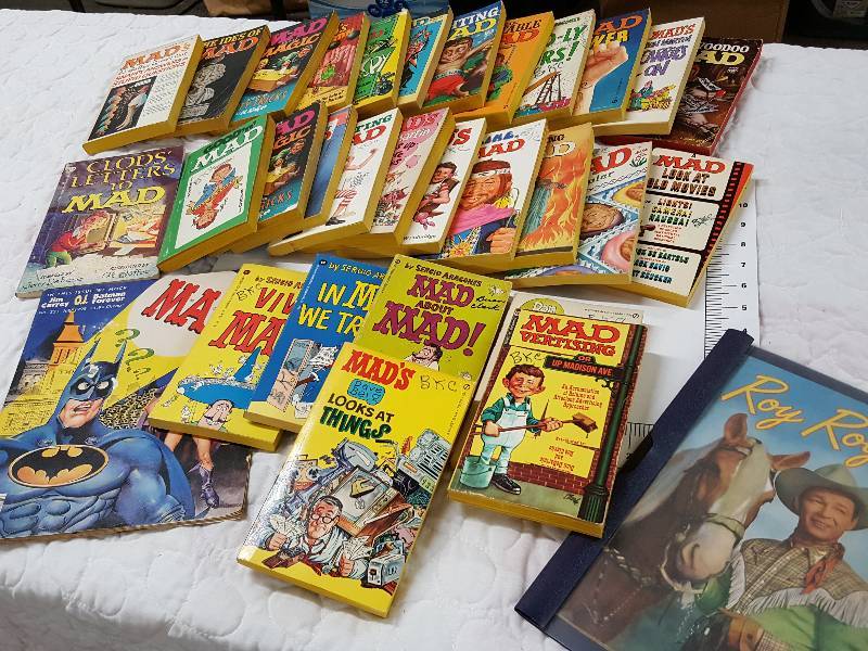 lot 1165 image: Definitely out of the 50s or 60s is this package of 30 MAD Magazine pocket books and one real cool old Roy Rogers comic book