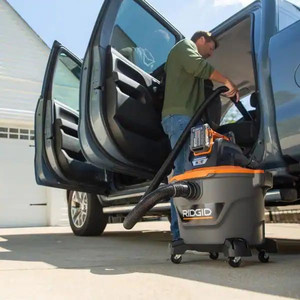 lot 23497 image: RIDGID - 9 Gal. 18-Volt Cordless NXT WetDry Shop Vacuum (Tool Only) with Filter Hose and Accessories, OrangesPeaches - Retail $109.00