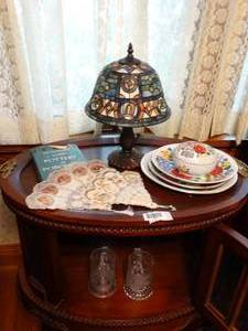 lot 1469 image: Contents on and in Oval Antique Cabinet   Tiffany Style Lamp  Vintage Hungarian China  Etc
