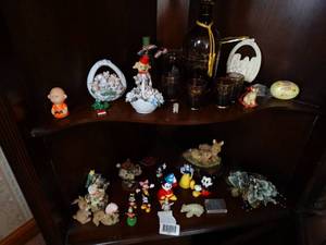 lot 1569 image: Contents on Bottom 2 Shelves on In Wood Corner Cabinet  Bottle & Glasses  Disney  Misc Nick Nacks