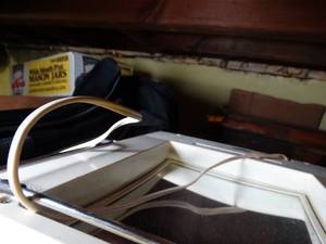 lot 1795 image: Mixed Lot on Top Left side of Shelves  Mylar Roll  Racket  Make-up Mirror  Misc