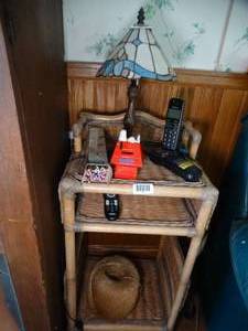 lot 1866 image: Contents of End Table  Tiffany Style Lamp  Phones  Snoopy Bank  Long Matches  Twine