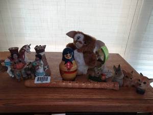 lot 1881 image: Decor on Top of TV Cabinet  Gizmo Gremlin  Nesting Dolls  Flute  Misc