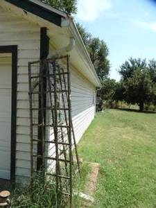 lot 1934 image: Homemade Wood and Metal Lattice both sides of Garage