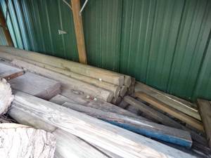 lot 1973 image: Nice Wood Fence Posts under Lean-to