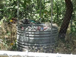 lot 1998 image: Round Metal stock tank  wContents  MIsc Hoses