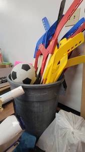 lot 9673 image: Trash Can of Basketballs, Hockey Sticks, Mikasa S3000 Size 5 Soccer Balls and More