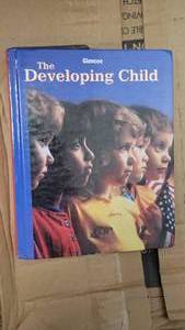 lot 9692 image: Box of 14 Glencoe The Developing Child School Curriculum Textbooks&nbsp