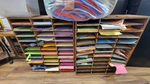 lot 9782 image: Lott of 2 Wooden Laminate Shelfs for Paper W Colorful Paper and a Doube Sided Wooden Magazine Rack