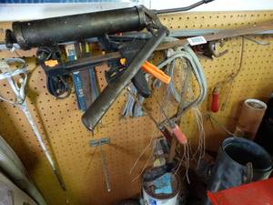 lot 1118 image: Grease Gun  Hack Saws  Paint Mixer  Items on Peg Board