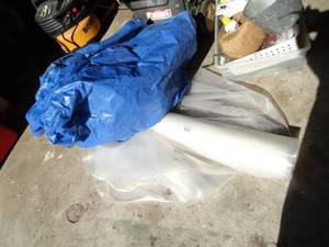 lot 1307 image: Blue Tarp and Roll of Plastic