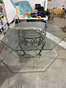 lot 1043 image: Iron and glass dining room table 32 x 82 the glass is three-quarter inch beveled glass very heavy bring help