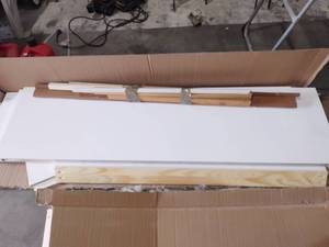 lot 1128 image: White unassembled cabinet unknown size with assorted trim pieces
