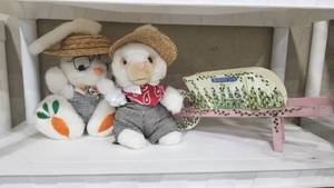 lot 2024 image: 2 stuffed bunnies and wheelbarrow