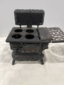 lot 1094 image: Crescent cast-iron miniature stove