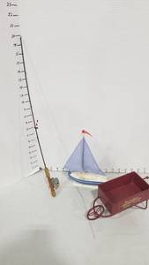 lot 2058 image: Doll fishing pole, sailboat and metal cart