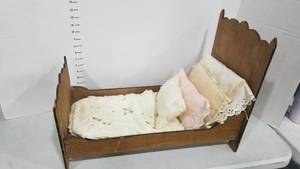 lot 2063 image: Large doll bed and bedding 16 x 22 x 12