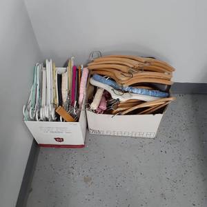 lot 3002 image: (2) Boxes of hangers. Alot of wooden hangers