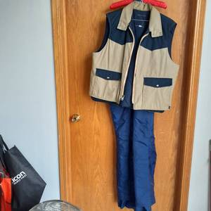 lot 3018 image: Mens vest(XL), has a small hole, and snow bibs ( XXL) one strap needs sewn back on