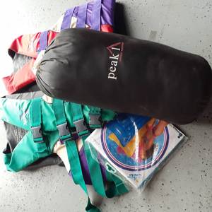 lot 3072 image: Adult life vests with Peak 1 sleeping bag and a blow up raft