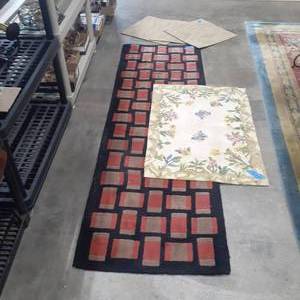 lot 1061 image: (3) Miscellaneous rugs. Different sizes. Runner looks like brick 88 x 27, Flowers and butterflies 39 x 27, and (3) carpet tiles 20 x 20each