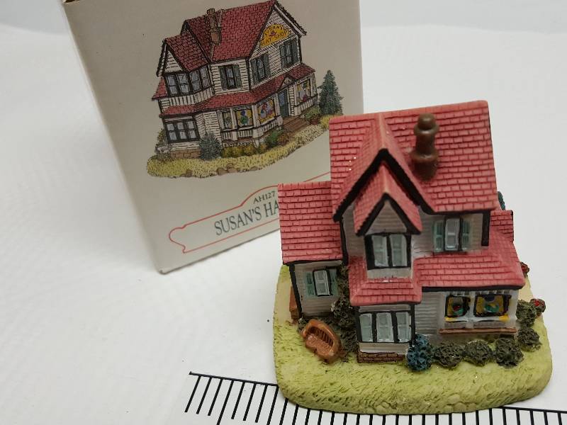 lot 8461 image: Ceramic table top piece sold by Dillards in the 90s as a collectable depicting shops from Liberty Falls