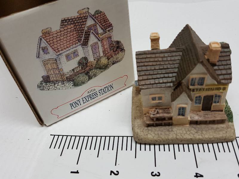 lot 8464 image: Ceramic table top piece sold by Dillards in the 90s as a collectable depicting shops from Liberty Falls